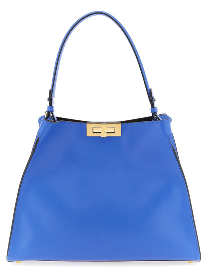 Medium Handbag by Fendi for women in calfskin leather blue & gold presents a ornamental silhouette, showcasing a secure snap & button, ample , and versatile adjustable-strap & handle for a ornamental finish.