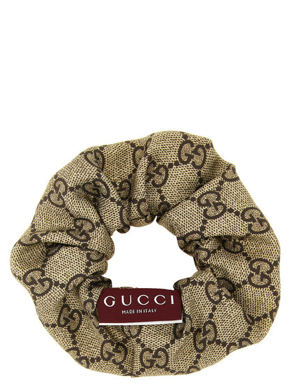 Ponytail Holder by Gucci for women in silk cashmere & sequins beige, brown, multicolor, red, white, patterned & monogram features an ornamental design, showcasing the signature aesthetic of the Gg Silk Ponytail Holder with an ornamental finish.