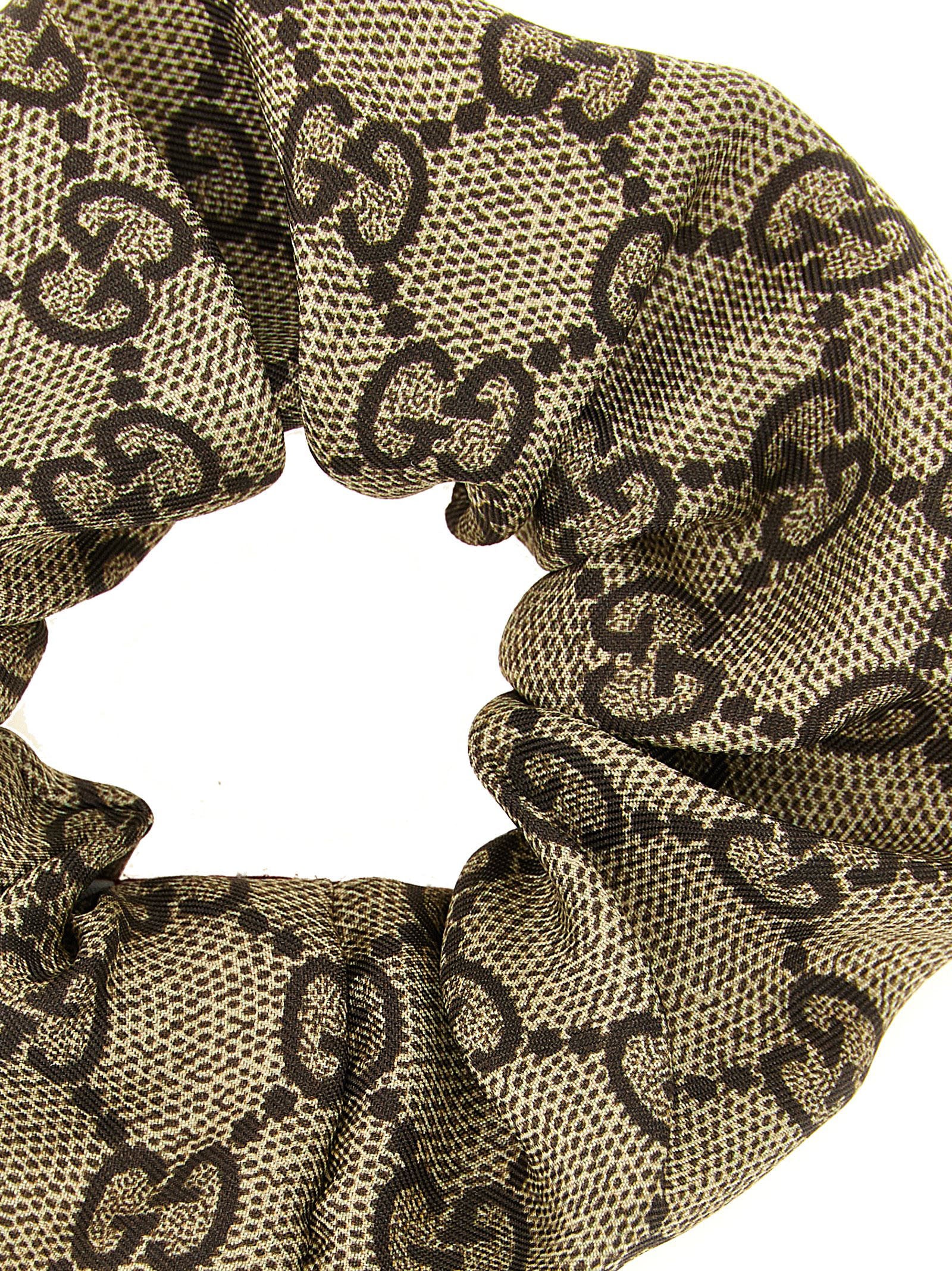 Ponytail Holder by Gucci for women in silk cashmere & sequins beige, brown, multicolor, red, white, patterned & monogram features a regal finish, perfectly showcasing the sophisticated design of the Gg Silk Ponytail Holder.