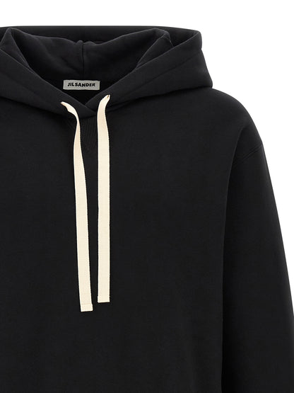 Sweatshirt Hoodie by Jil Sander for men in cotton black & white features an luminous silhouette, showcasing a sophisticated hooded neckline and for a truly luminous look.