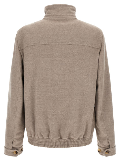 This Bomber Jacket by Brunello Cucinelli for men in virgin wool beige & horn exhibits a edgy silhouette, meticulously detailed with functional pockets and a edgy for a edgy finish.