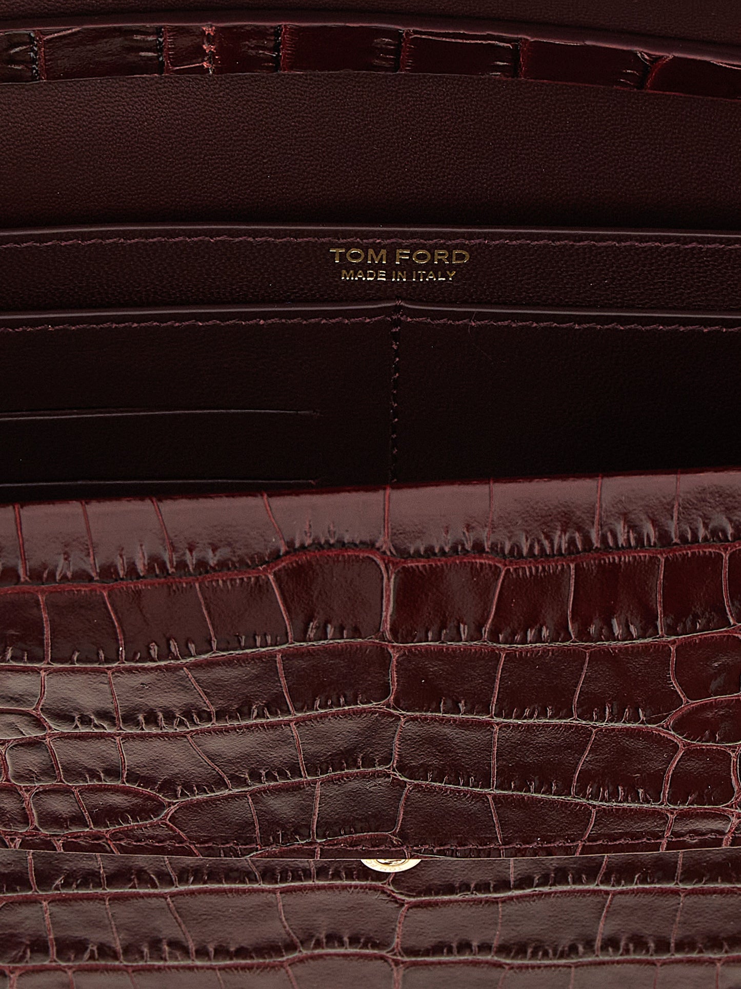 Mini Crossbody Clutch Handbag by Tom Ford for women in bio-acetate bordeaux, gold & print features a sculptural silhouette with a secure , organized built-in-compartments & cardholder, and versatile crossbody-strap & adjustable-strap for a sculptural finish.