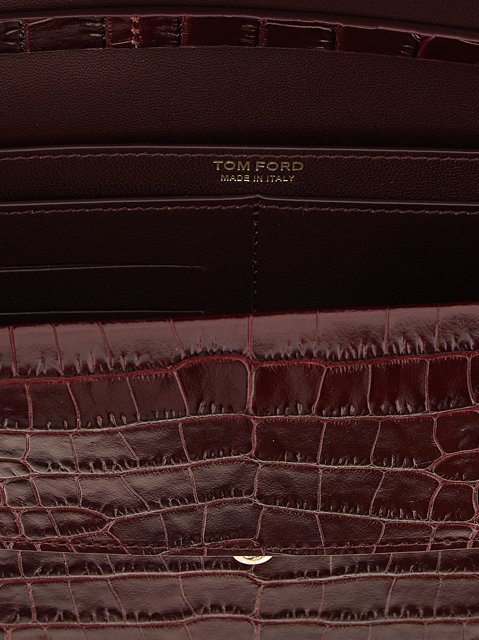 Mini Crossbody Clutch Handbag by Tom Ford for women in bio-acetate bordeaux, gold & print features a sculptural silhouette with a secure , organized built-in-compartments & cardholder, and versatile crossbody-strap & adjustable-strap for a sculptural finish.