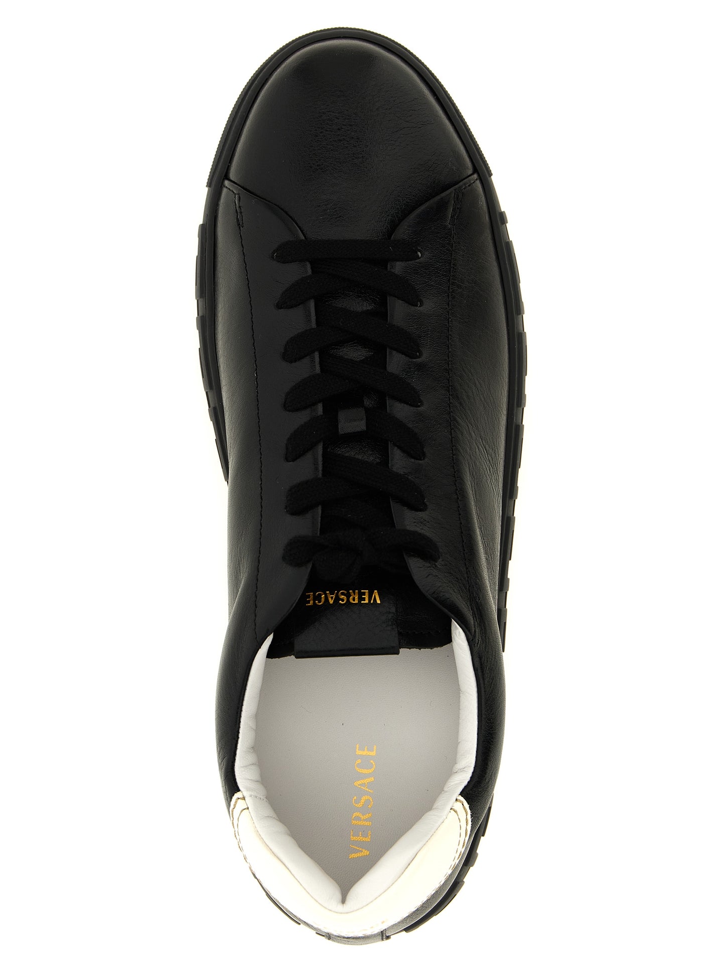 Sneakers by Versace for men in calfskin leather bicolour, black, gold, white, patterned & signature presents a sumptuous silhouette, artfully capturing the essence of the Play Men's Low Top Calfskin Leather Sneakers with its sumptuous low-top style design.