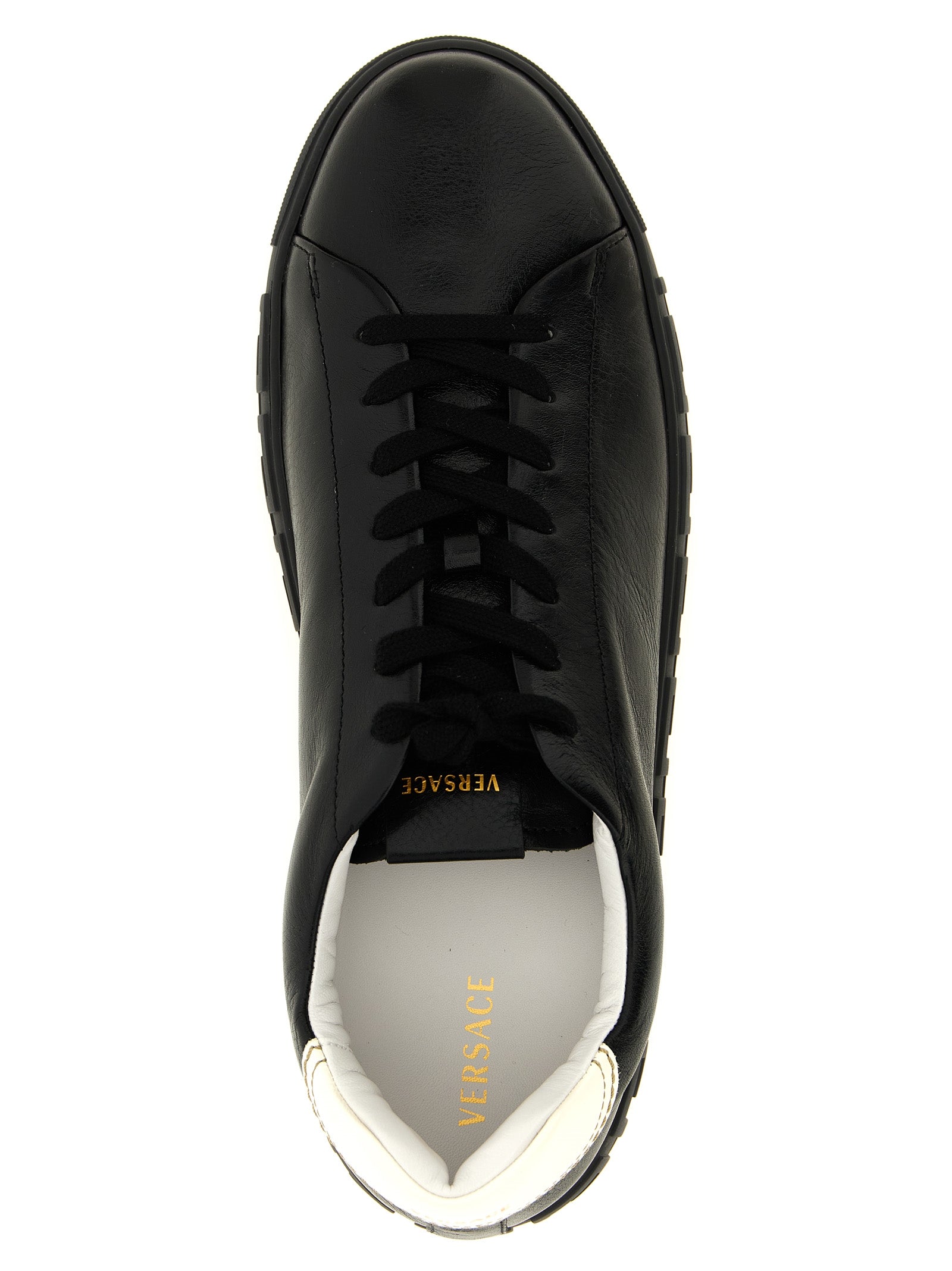 Sneakers by Versace for men in calfskin leather bicolour, black, gold, white, patterned & signature presents a sumptuous silhouette, artfully capturing the essence of the Play Men's Low Top Calfskin Leather Sneakers with its sumptuous low-top style design.