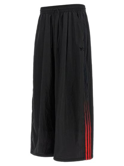 Activewear Pants by Y-3 for men in polyamide gradient, black, red & striped features an streamlined design with , highlighting a streamlined athletic, relaxed-fit & wide and long cut with a comfortable .