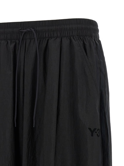 Activewear Pants by Y-3 for men in polyamide gradient, black, red & striped features an sporty athletic, relaxed-fit & wide with a long and , expertly finished with for an sporty performance aesthetic.