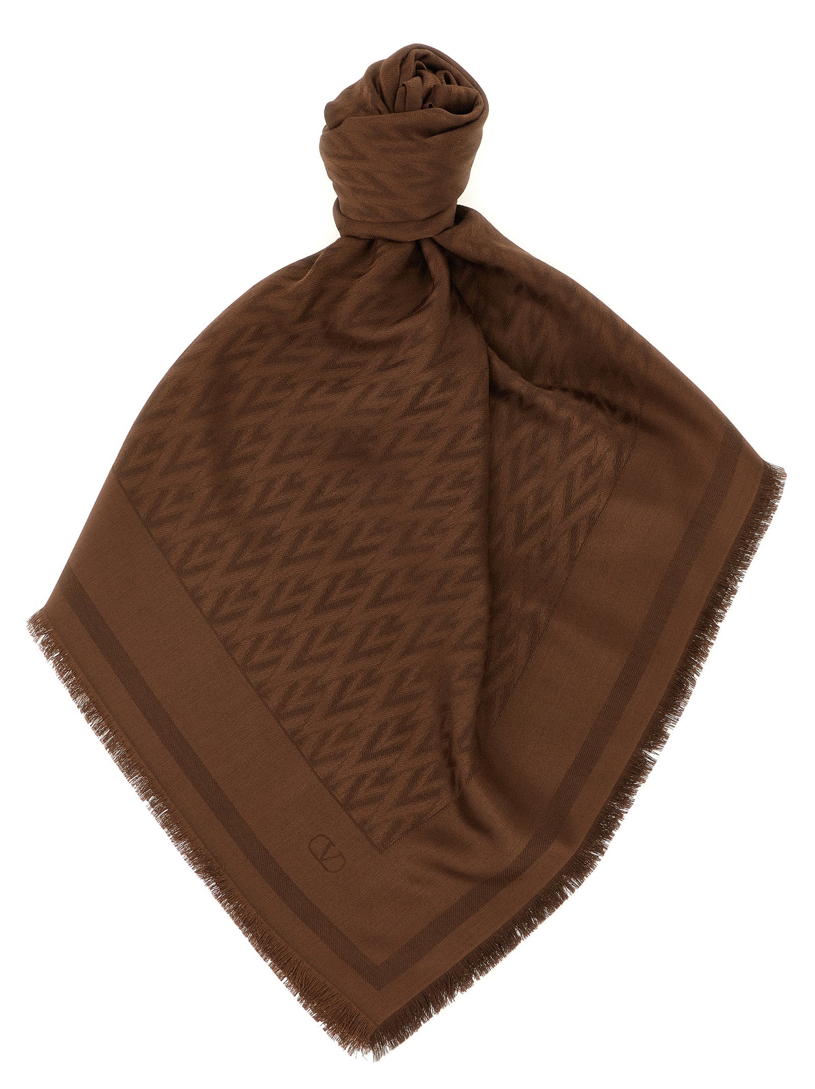 Scarf by Valentino Garavani for women in wool & silk brown, jacquard & signature presents a effortlessly chic silhouette, artfully capturing the essence of the effortlessly chic V Logo Wool & Silk Rectangular Wrap Fringes Scarf design for a sophisticated look.