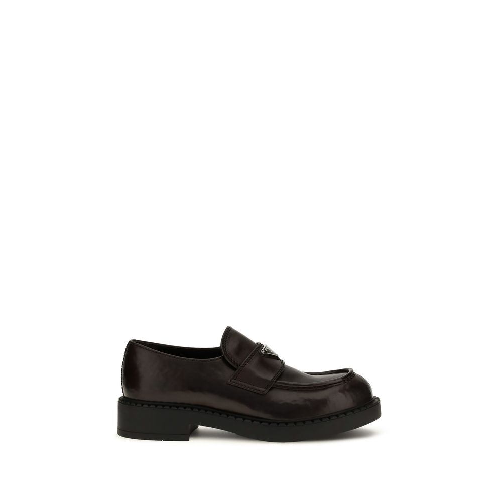 Loafer Slip-On Strap Shoes by Prada for men in bos taurus calf leather brown features an effortless chic silhouette, showcasing the Men's Bos Taurus Calf Leather Loafer Slip-On Strap Shoes design with an effortless chic and a for a effortless chic look.