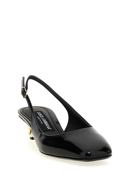 This Mid-Heel Slingback Pumps Heels by Dolce & Gabbana for women in calfskin leather & carbon black & gold presents a effortlessly chic silhouette from the Jackie Women's Calfskin Leather & Carbon Mid-Heel Slingback Pumps Heels collection, featuring a effortlessly chic mid-heel and effortlessly chic square toe style.
