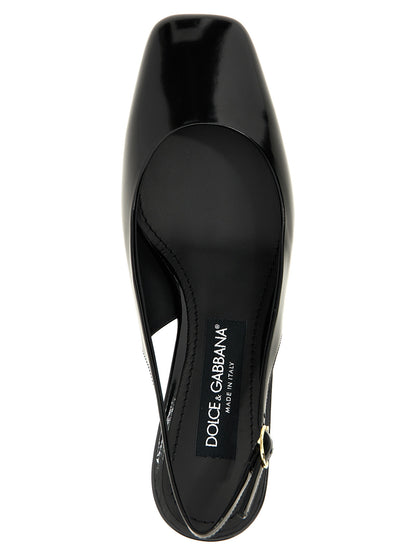 Mid-Heel Slingback Pumps Heels by Dolce & Gabbana for women in calfskin leather & carbon black & gold features an captivating silhouette, showcasing the elegant Jackie Women's Calfskin Leather & Carbon Mid-Heel Slingback Pumps Heels design with a mid-heel and a sophisticated square toe style.