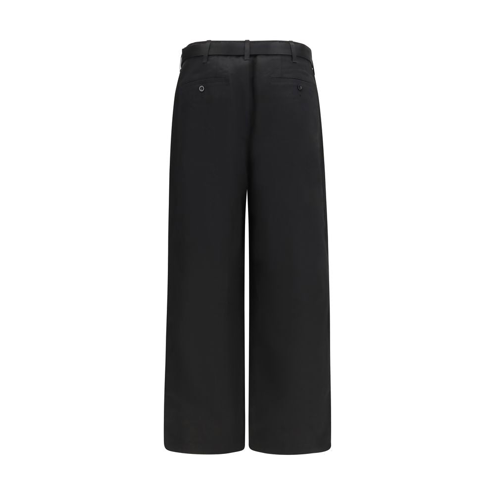 Chinos Pants by Sacai for men in black features an contemporary silhouette, showcasing a sophisticated wide & oversized and long with a refined for a truly contemporary aesthetic.