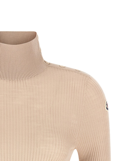 Cardigan by Moncler for women in merino virgin wool beige features a nuanced silhouette with a refined turtle neckline and nuanced detailing for a sophisticated look.