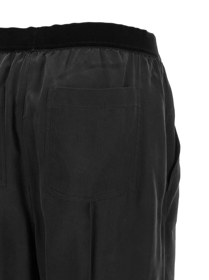 Pajamas by Tom Ford for women in silk black features a avant-garde silhouette, artfully capturing the essence of the avant-garde Women's Silk Pajamas design for a sophisticated and relaxed look.