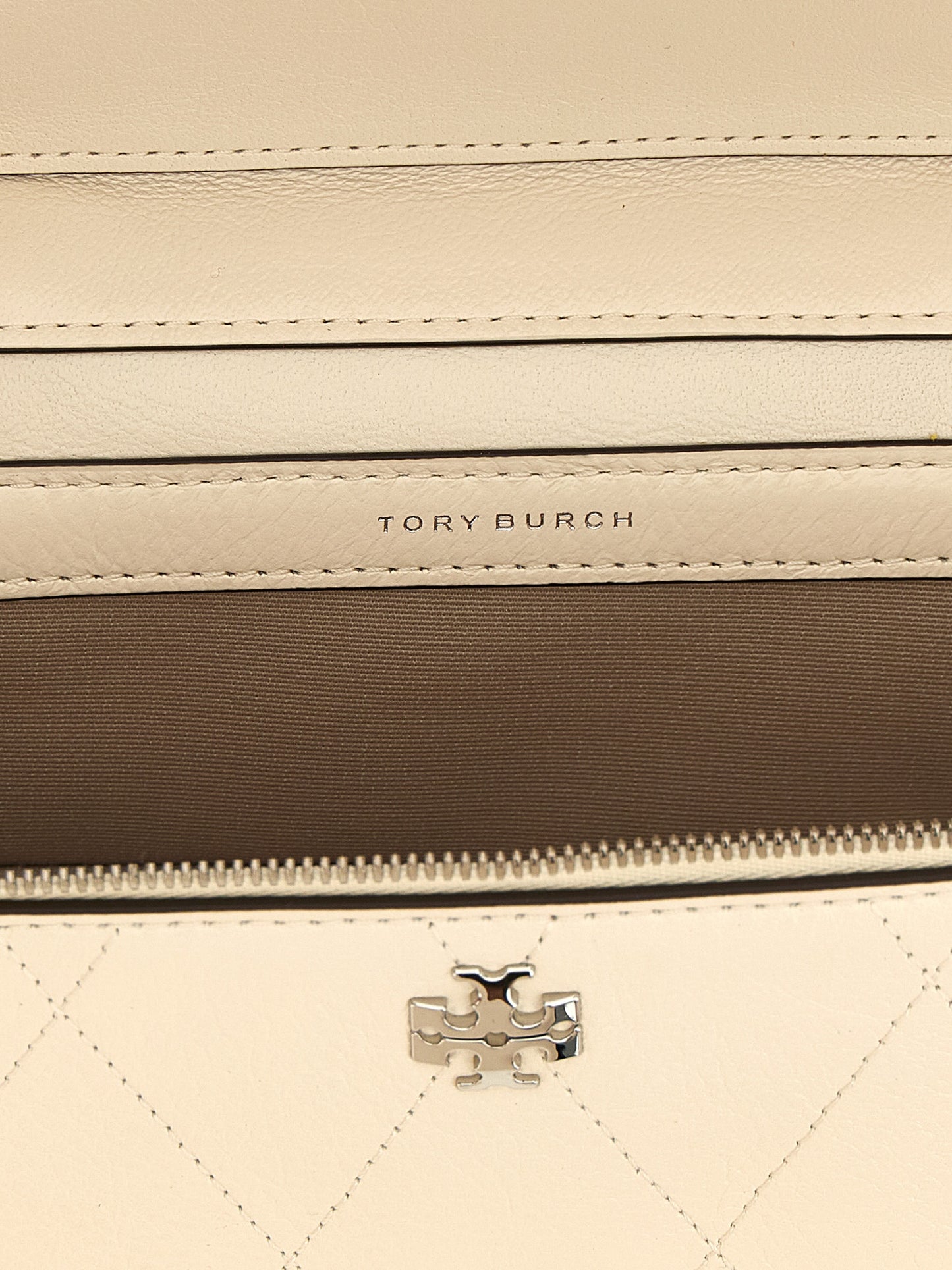 Crossbody Quilted Vanity Handbag by Tory Burch for women in leather cream, silver, white & signature features an versatile silhouette, showcasing a secure zipper and versatile built-in-compartments & cardholder with versatile crossbody-strap, shoulder-strap, handle & detachable-strap for a versatile finish.