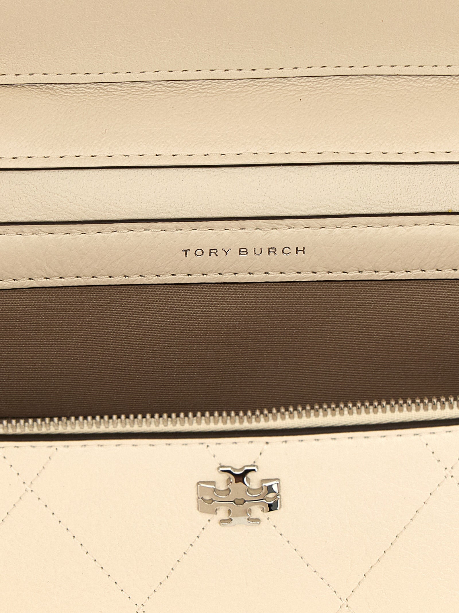 Crossbody Quilted Vanity Handbag by Tory Burch for women in leather cream, silver, white & signature features an versatile silhouette, showcasing a secure zipper and versatile built-in-compartments & cardholder with versatile crossbody-strap, shoulder-strap, handle & detachable-strap for a versatile finish.
