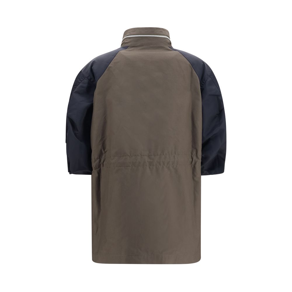 Windbreaker Jacket by Sacai for women in nylon cotton bicolour features an magnificent silhouette, showcasing the sophisticated high-collar neckline and functional pockets & windproof for a premium, magnificent look.