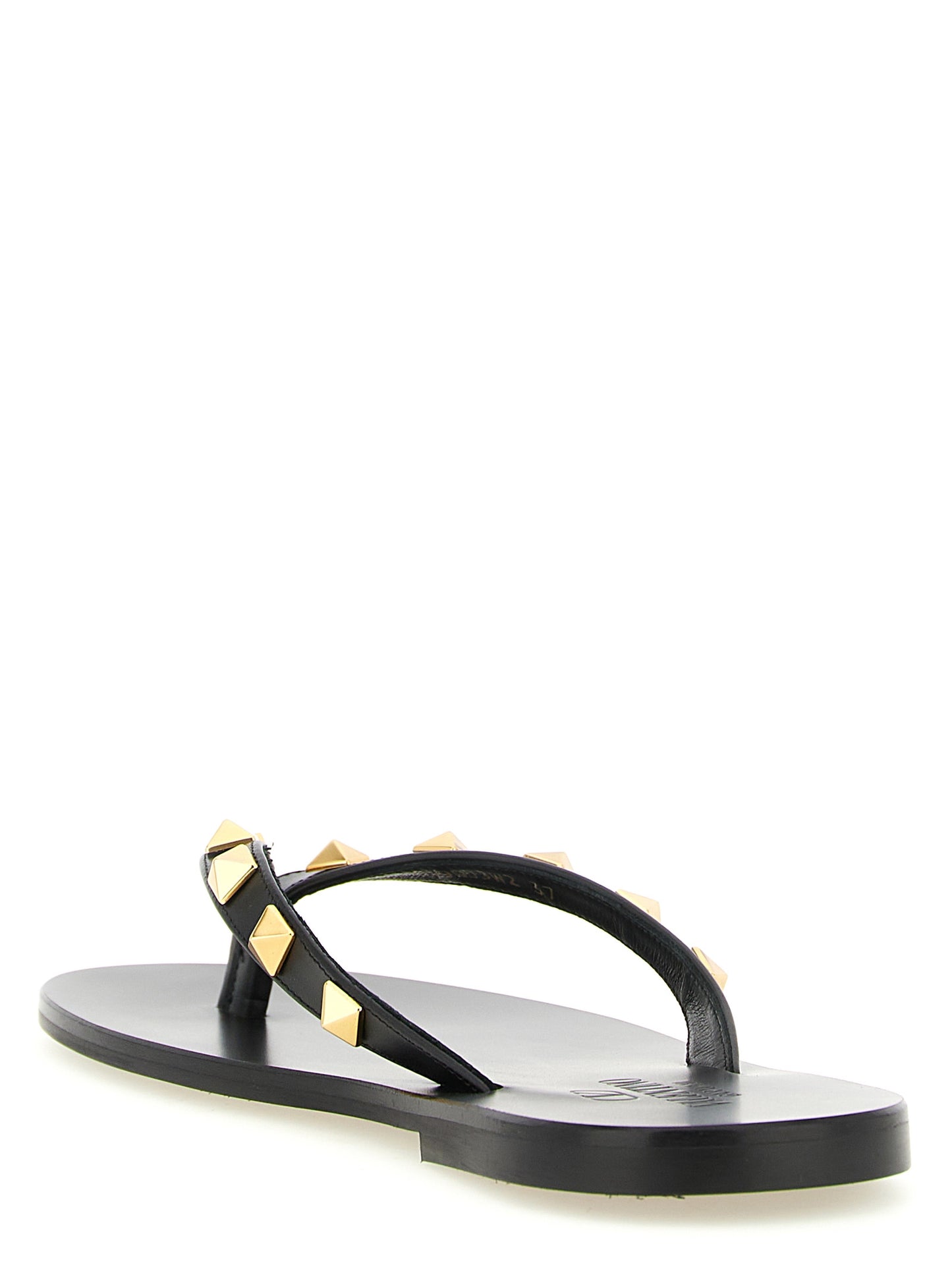 Sliders Sandals Flat Shoes by Valentino Garavani for women in calfskin leather & brass black features an statuesque silhouette from the Rockstud Women's Calfskin Leather & Brass Sliders Sandals Flat Shoes collection, showcasing a and a statuesque for a statuesque look.