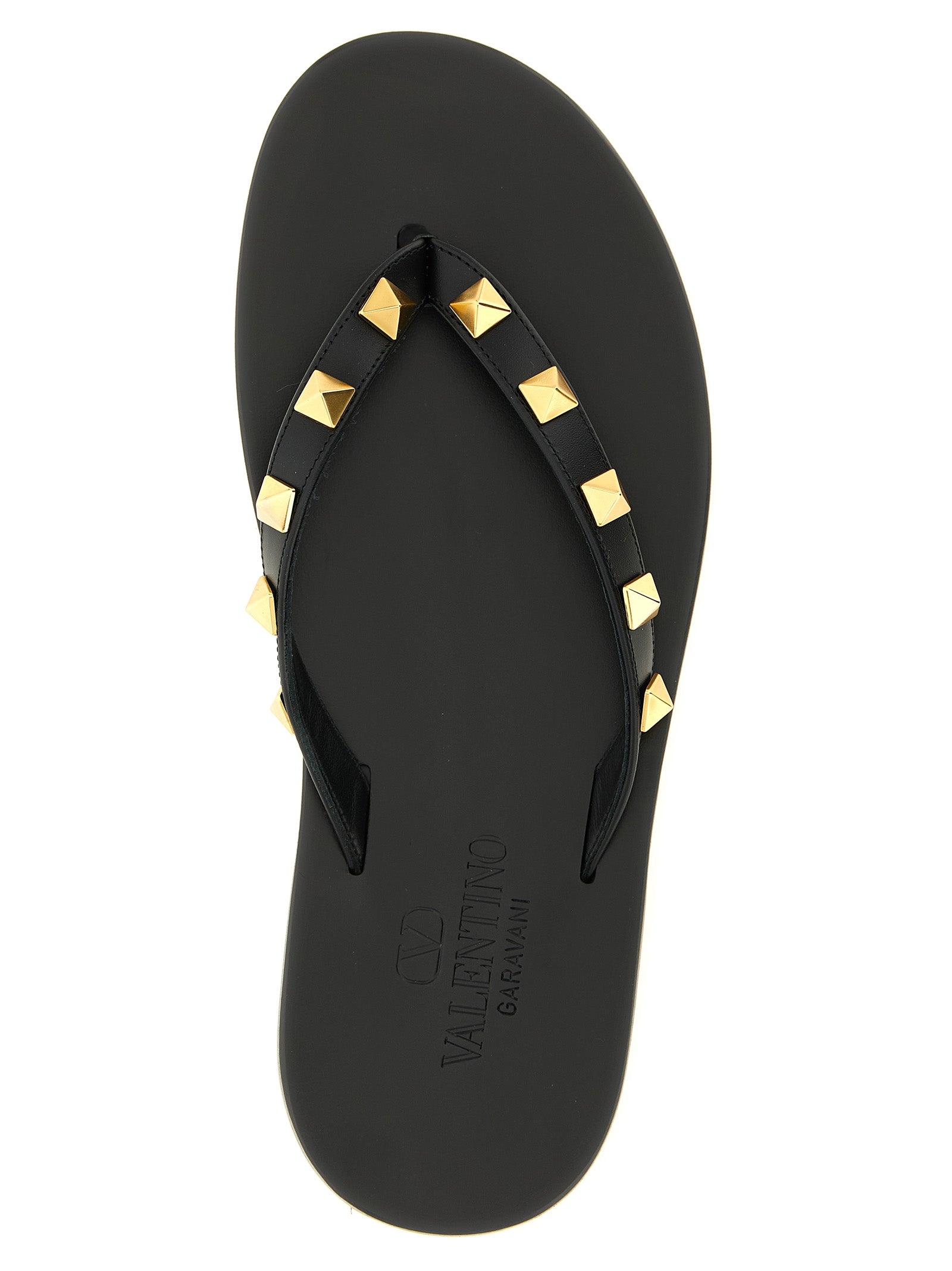 Sliders Sandals Flat Shoes by Valentino Garavani for women in calfskin leather & brass black presents a impeccable silhouette as Rockstud Women's Calfskin Leather & Brass Sliders Sandals Flat Shoes, artfully designed with a and a impeccable for a refined, upscale finish.