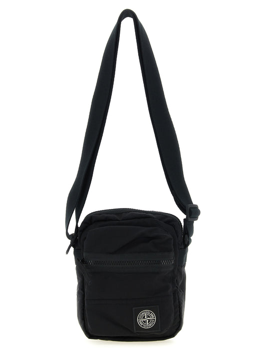 Compact Crossbody Messenger Bag by Stone Island for men in nylon black features a distinguished Nylon Compact Crossbody Messenger Bag design with a secure snap, zipper & button, ample , and versatile crossbody-strap & adjustable-strap for a distinguished look.