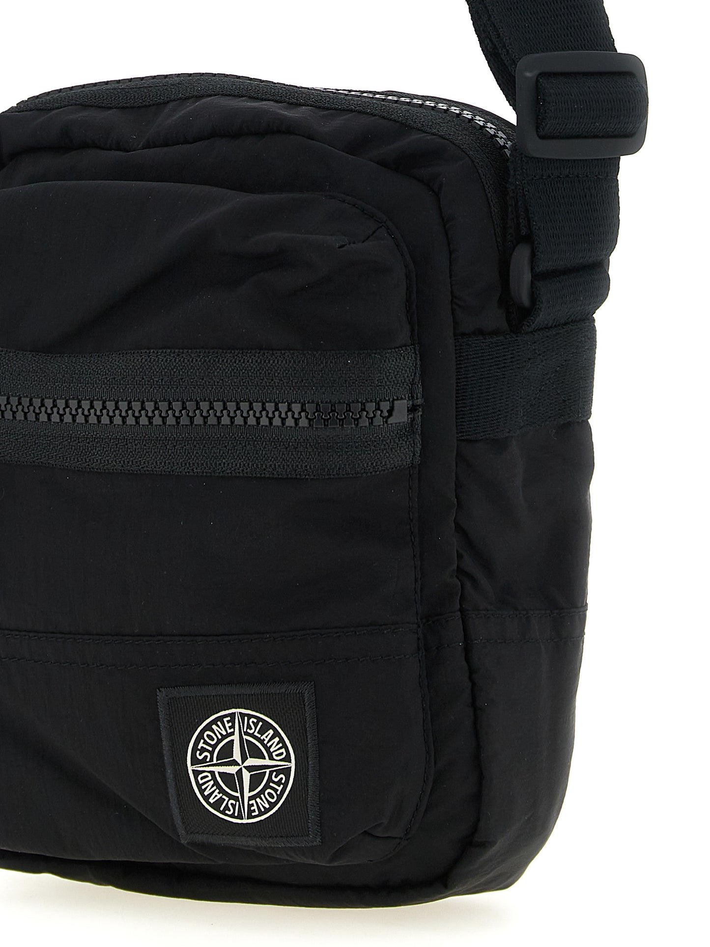 Compact Crossbody Messenger Bag by Stone Island for men in nylon black features a artisanal Nylon Compact Crossbody Messenger Bag design with a secure snap, zipper & button, ample , and versatile crossbody-strap & adjustable-strap for a artisanal finish.