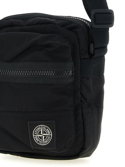 Compact Crossbody Messenger Bag by Stone Island for men in nylon black features a artisanal Nylon Compact Crossbody Messenger Bag design with a secure snap, zipper & button, ample , and versatile crossbody-strap & adjustable-strap for a artisanal finish.