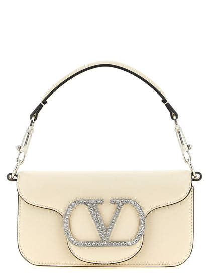 Small 2-in-1 Shoulder & Crossbody Flap Bag by Valentino Garavani for women in bos taurus suede calf leather white & signature features a effortless sophistication silhouette, secured by a flap & magnetic with ample and versatile crossbody-strap, shoulder-strap, detachable-strap & handle for a effortless sophistication finish.