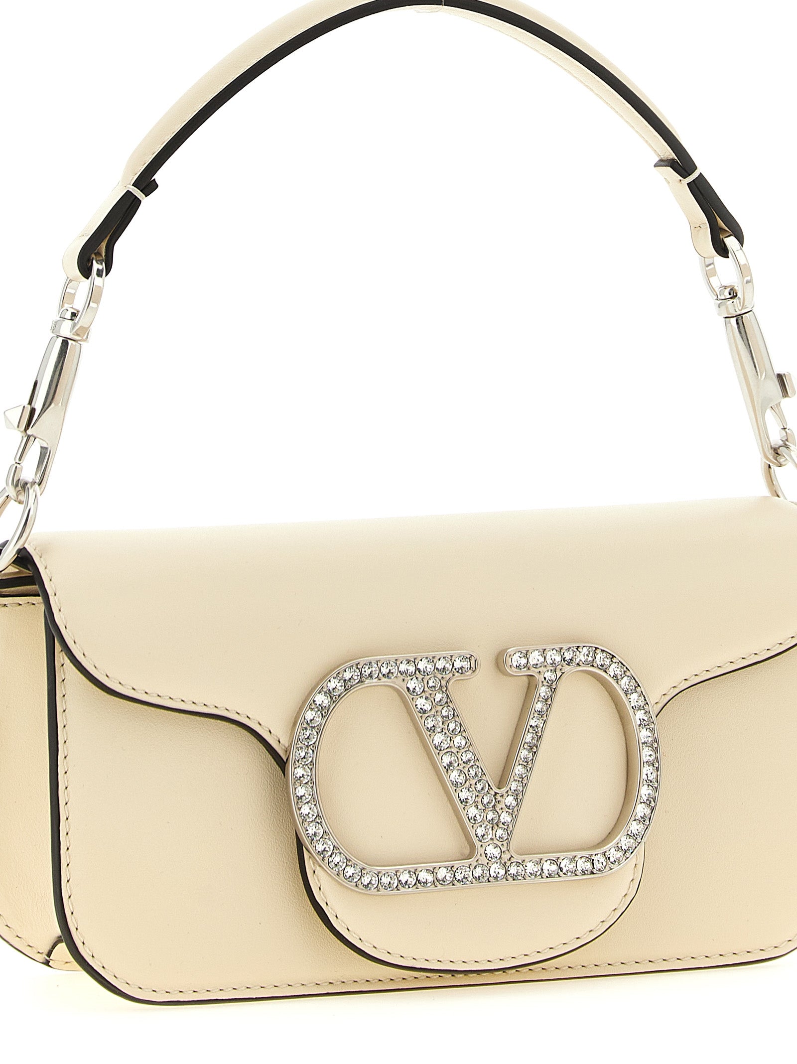 Small 2-in-1 Shoulder & Crossbody Flap Bag by Valentino Garavani for women in bos taurus suede calf leather white & signature features a enviable silhouette, showcasing a secure flap & magnetic, ample , and enviable crossbody-strap, shoulder-strap, detachable-strap & handle for a enviable finish.