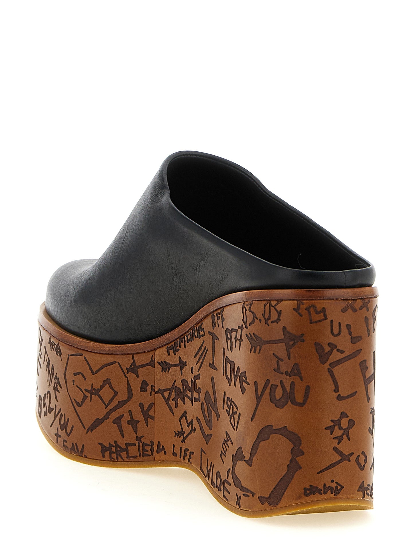 Wedge Sandals by Chloé for women in wood & calfskin leather and black presents a captivating silhouette, showcasing the signature style of the Aren Women's Wood & Calfskin Leather Wedge Sandals with a captivating wedge and captivating .