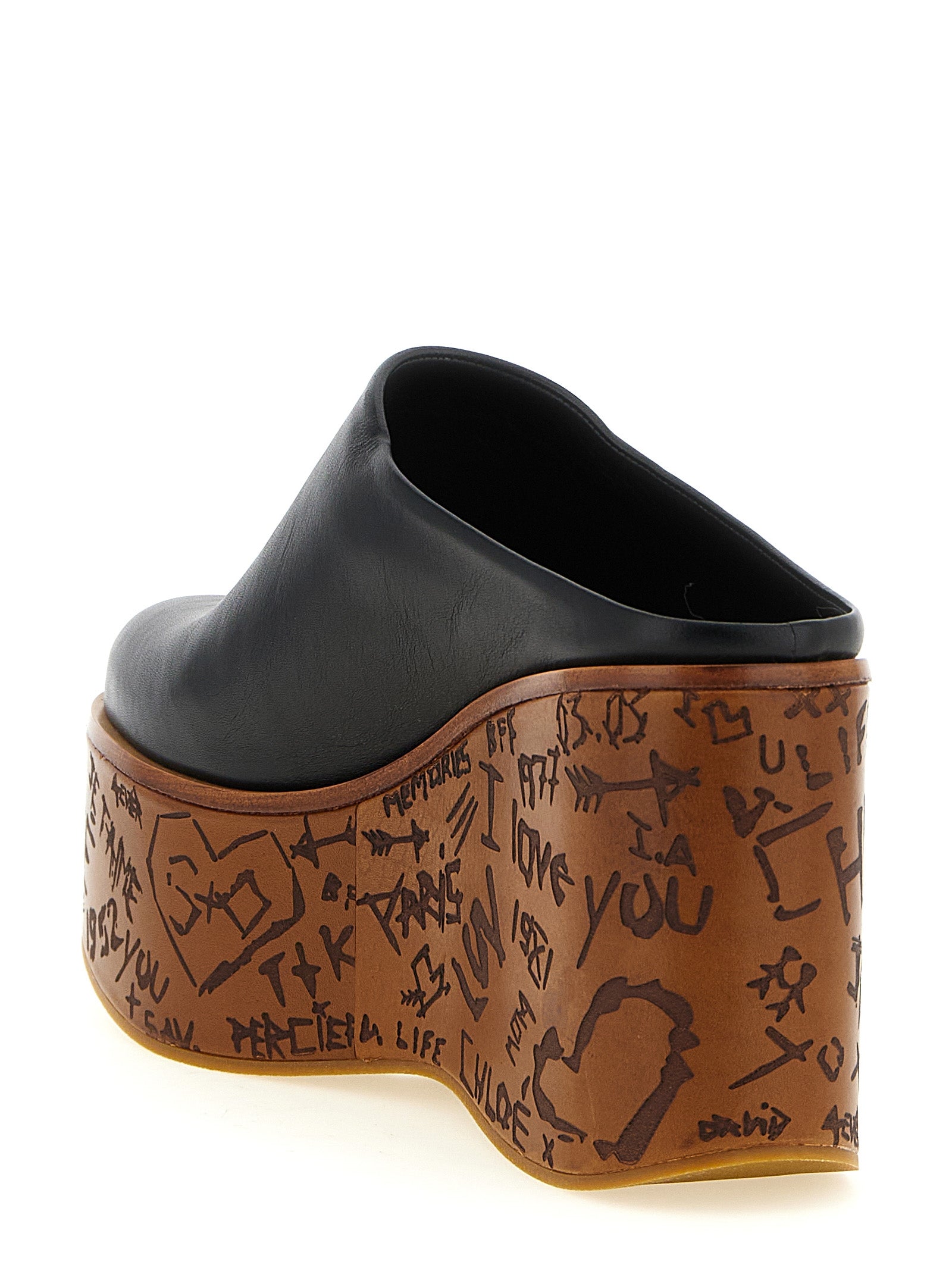 Wedge Sandals by Chloé for women in wood & calfskin leather and black presents a captivating silhouette, showcasing the signature style of the Aren Women's Wood & Calfskin Leather Wedge Sandals with a captivating wedge and captivating .