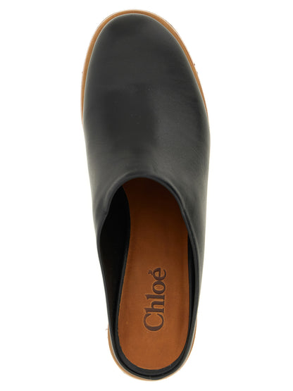 Wedge Sandals by Chloé for women in wood & calfskin leather black presents a sculptural silhouette, showcasing the Aren Women's Wood & Calfskin Leather Wedge Sandals design with a sculptural wedge and for a premium look.