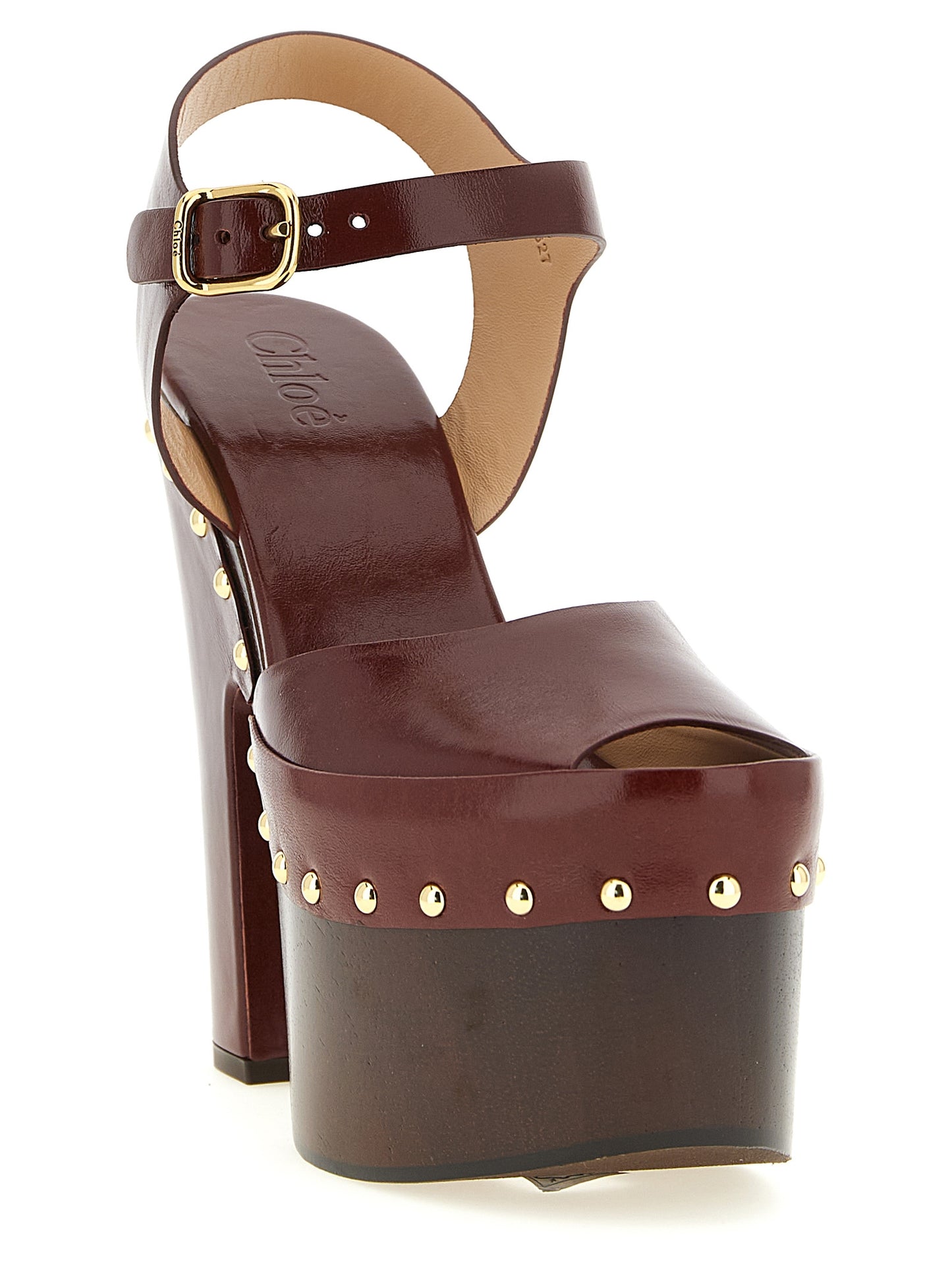 Platform Stiletto Ankle Strap Clogs Sandals by Chloé for women in embossed lamb leather burgundy & gold features an architectural design from the Women's Embossed Lamb Leather Platform Stiletto Ankle Strap Clogs Sandals collection, defined by a architectural stiletto platform and for a architectural finish.