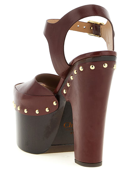 Platform Stiletto Ankle Strap Clogs Sandals by Chloé for women in embossed lamb leather burgundy & gold features an exquisite silhouette, showcasing the exquisite Women's Embossed Lamb Leather Platform Stiletto Ankle Strap Clogs Sandals with a stiletto platform and .