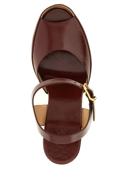 Platform Stiletto Ankle Strap Clogs Sandals by Chloé for women in embossed lamb leather burgundy & gold showcases a sculptural silhouette as Women's Embossed Lamb Leather Platform Stiletto Ankle Strap Clogs Sandals, defined by a sculptural stiletto platform and sculptural for a sculptural look.