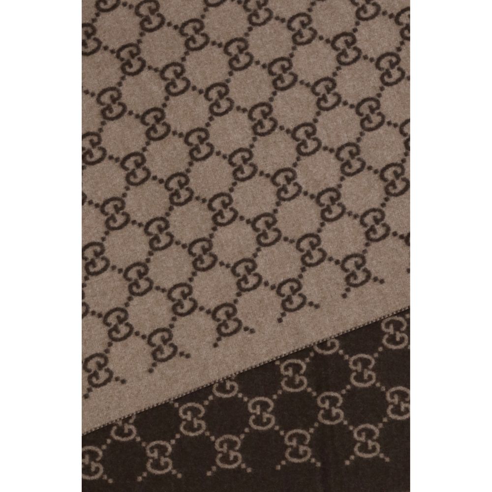 Scarf by Gucci for men in cashmere & capra leather brown & patterned showcases a warm silhouette from the Gg Cashmere & Capra Leather Fringes Scarf collection, offering a warm drape that exudes sophisticated luxury.