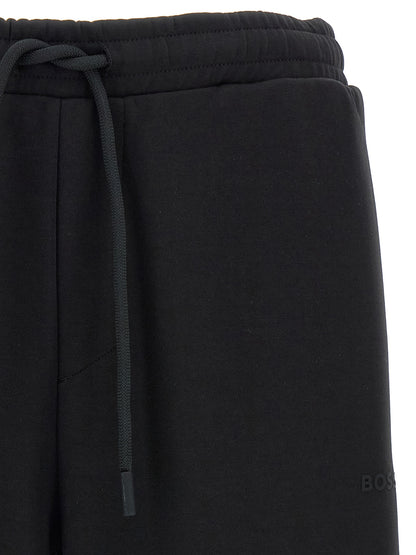 Joggers by Hugo Boss for men in stretch cotton black presents a refined pantology silhouette, artfully defined by a refined pantology , long, and a sophisticated .