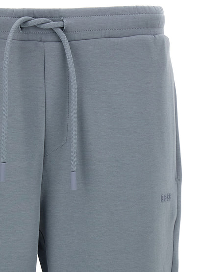 Joggers by Hugo Boss for men in stretch cotton gray presents a tailored silhouette, showcasing a tailored and long cut with a refined for a truly tailored aesthetic.
