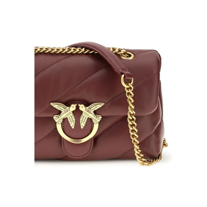 Mini 2-in-1 Shoulder & Crossbody Quilted Bag by PINKO for women in bos taurus calf leather bordeaux, gold & monogram showcases a enviable silhouette, artfully detailed with a secure magnetic & button, organized , and versatile crossbody-strap & shoulder-strap for a enviable look.