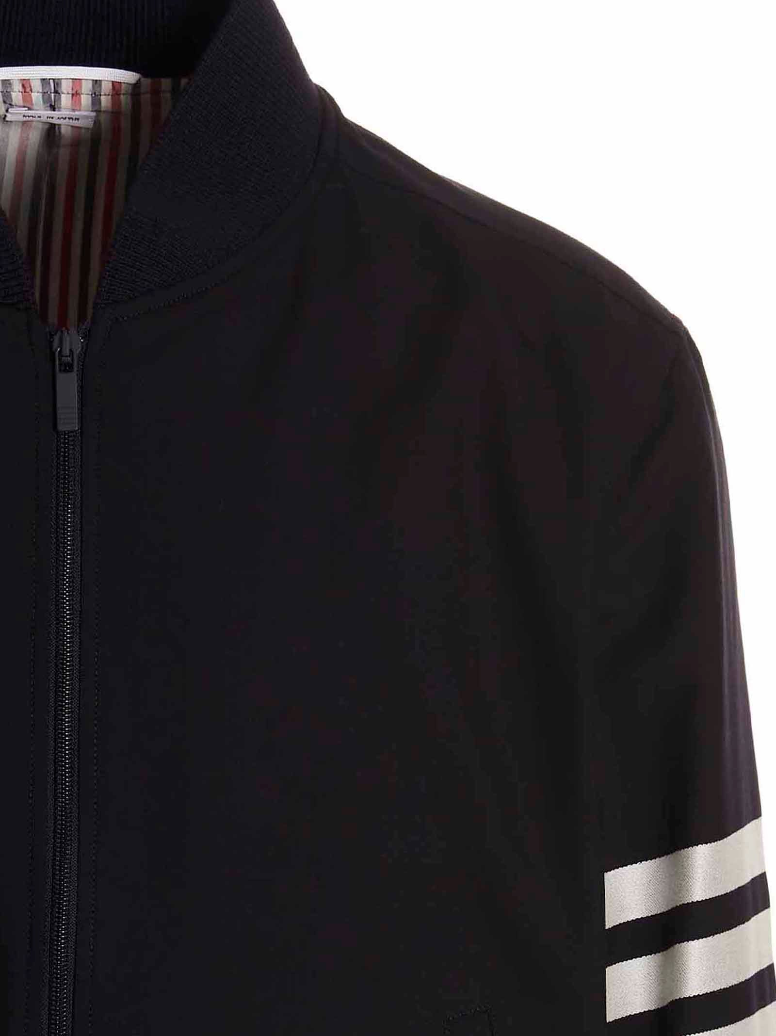 Bomber Jacket by Thom Browne for men in wool blue showcases a bohemian silhouette, artfully detailed with a bohemian and signature pockets for a truly bohemian finish.