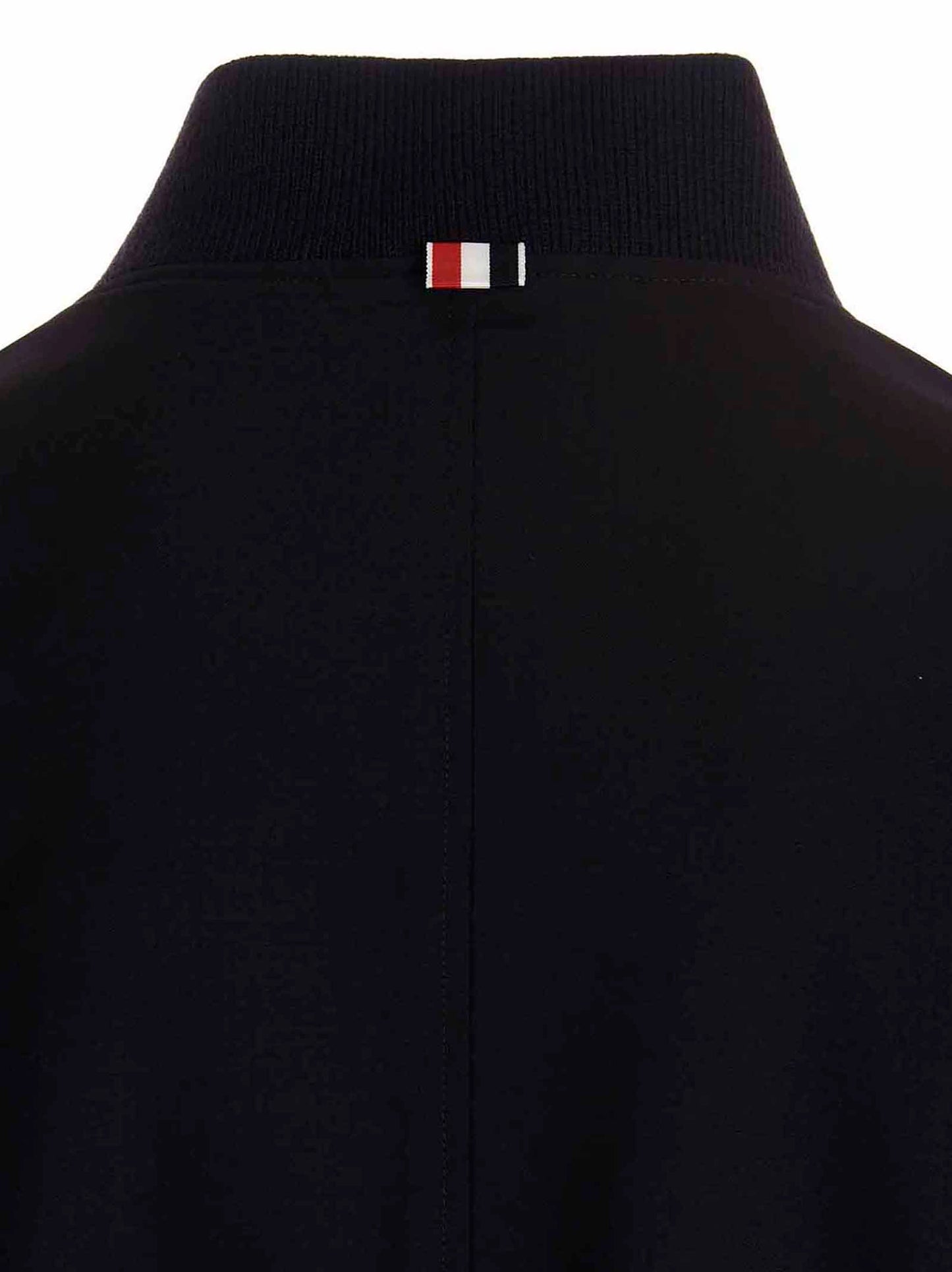 This Bomber Jacket by Thom Browne for men in wool blue exhibits a edgy silhouette, meticulously detailed with functional pockets and a edgy for a edgy finish.