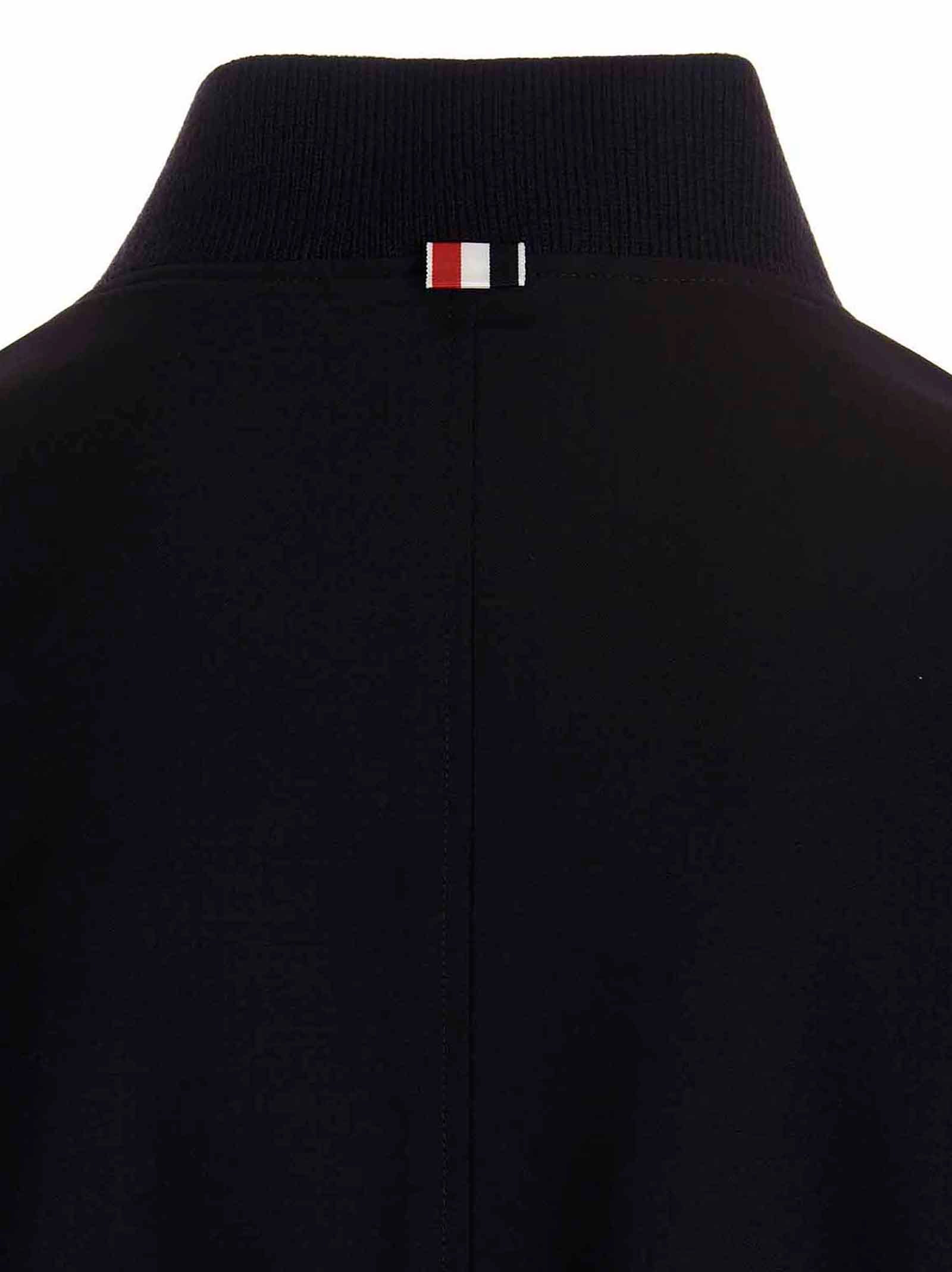 This Bomber Jacket by Thom Browne for men in wool blue exhibits a edgy silhouette, meticulously detailed with functional pockets and a edgy for a edgy finish.