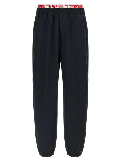 Joggers by Versace for men in polyamide black, gold & patterned presents a refined pantology silhouette, artfully defined by a refined pantology , long, and a sophisticated .