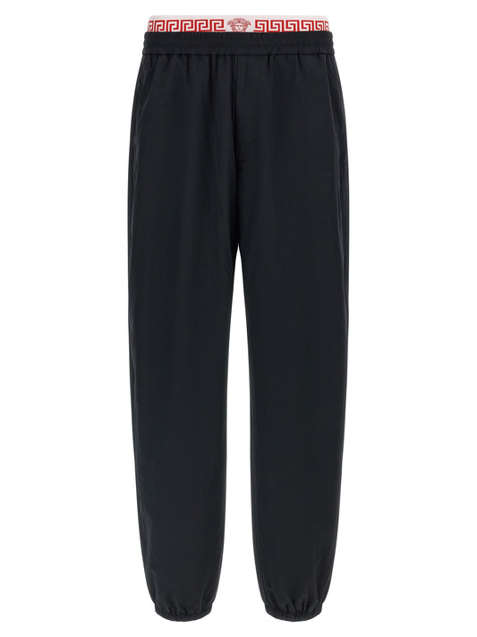 Joggers by Versace for men in polyamide black, gold & patterned presents a refined pantology silhouette, artfully defined by a refined pantology , long, and a sophisticated .