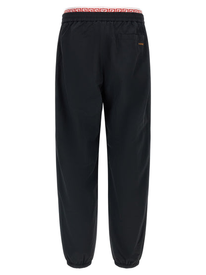 Joggers by Versace for men in polyamide black, gold & patterned features a refined silhouette with a refined , defined by a and a refined long for a refined finish.