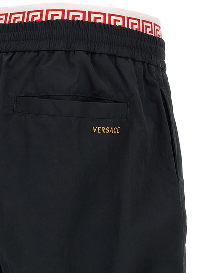 Joggers by Versace for men in polyamide black, gold & patterned features an refined tailoring silhouette, showcasing a premium with a and long cut for a refined tailoring look.