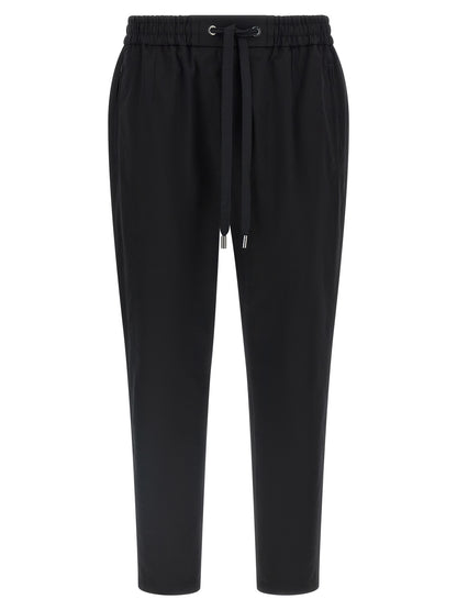 Casual Pants by Dolce & Gabbana for men in stretch cotton black presents a refined pantology silhouette, artfully defined by a refined pantology tapered-leg, long, and a sophisticated .