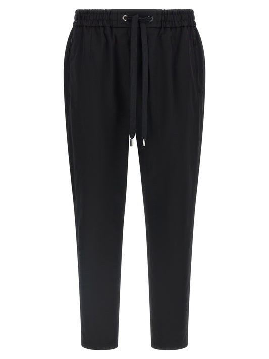 Casual Pants by Dolce & Gabbana for men in stretch cotton black presents a refined pantology silhouette, artfully defined by a refined pantology tapered-leg, long, and a sophisticated .