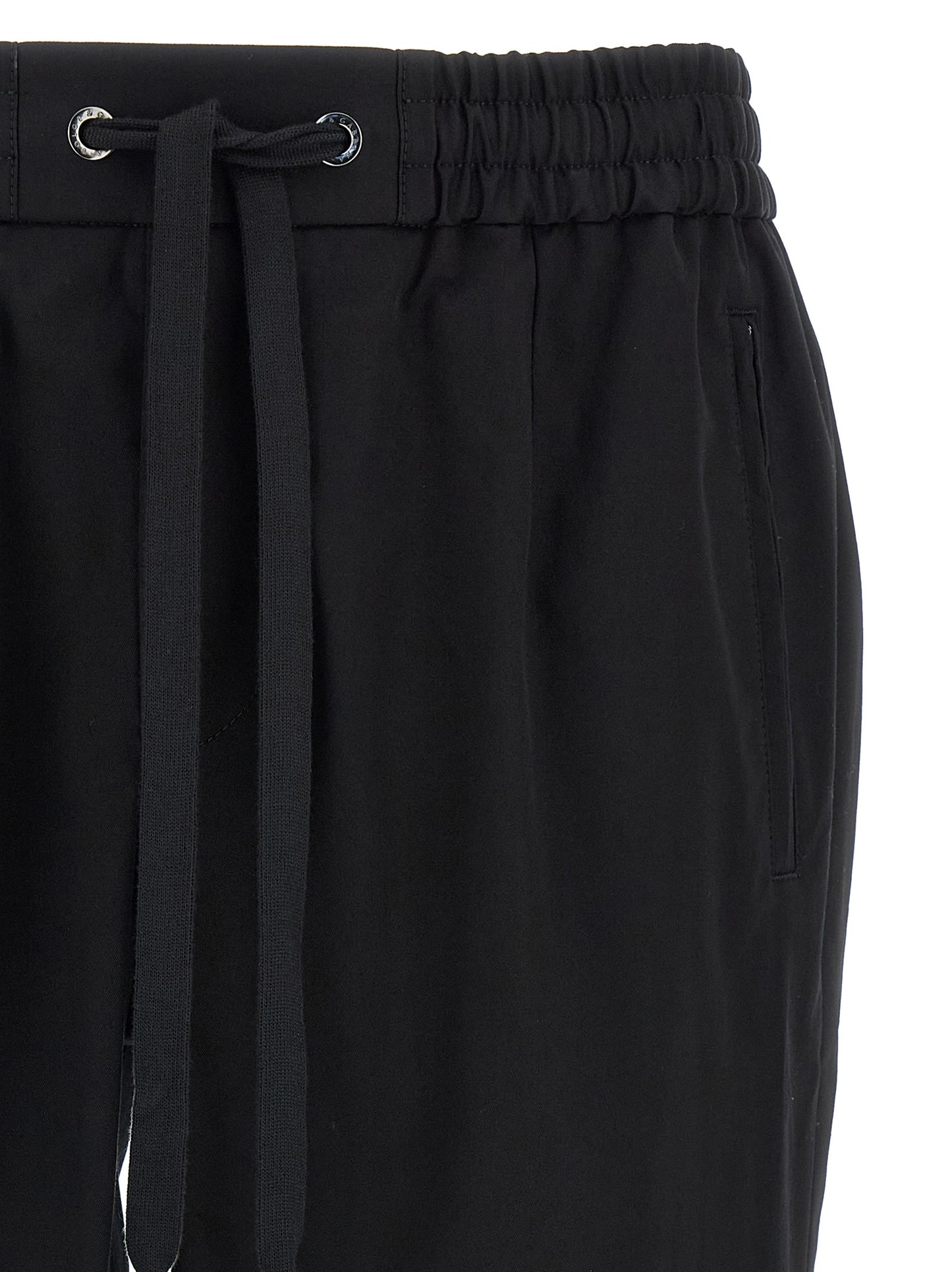 Casual Pants by Dolce & Gabbana for men in stretch cotton black features a polished silhouette with a polished tapered-leg, reaching a polished long and finished with a polished .