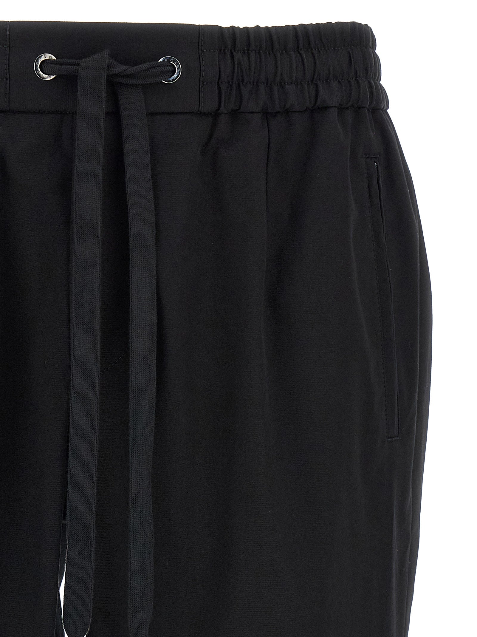 Casual Pants by Dolce & Gabbana for men in stretch cotton black features a polished silhouette with a polished tapered-leg, reaching a polished long and finished with a polished .