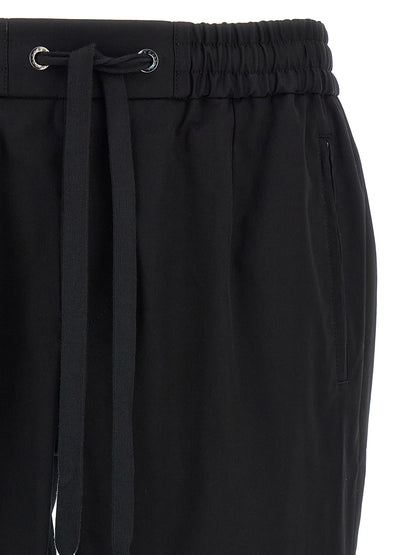 Casual Pants by Dolce & Gabbana for men in stretch cotton black features a polished silhouette with a polished tapered-leg, reaching a polished long and finished with a polished .